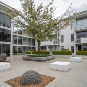 Lux Andringa Walk Apartments: a building with a tree in the courtyard