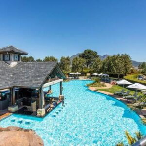 Luxury Lakeside Lodge at Jack Nicklaus Golf Estate: a swimming pool with chairs and umbrellas at a resort