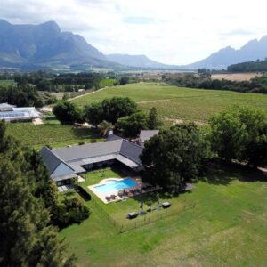Lynx Wine Estate: an aerial view of a house in a field with a pool