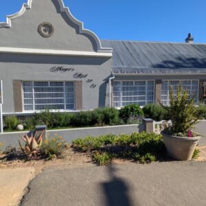 Mayors Rest on 44: a building with a clock on the side of it