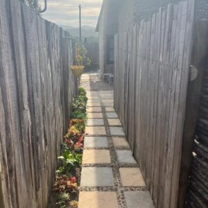 MiCasa SuCasa: a garden with a fence and a sidewalk
