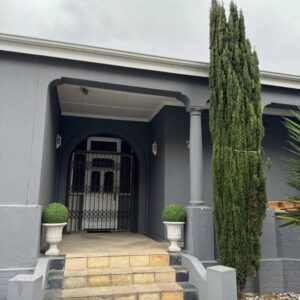 Michu Guest house: a blue house with a staircase and a gate