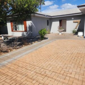 Milnerton 2 Queens and Kings Guest House: a brick driveway in front of a house