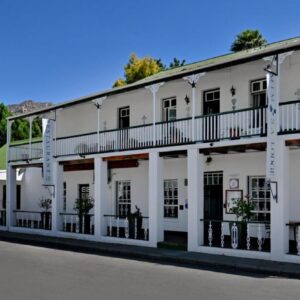 Mimosa Lodge: a white building with balconies on a street