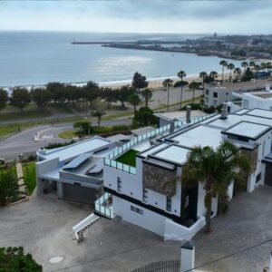 Mossel-Bay Waterfront Accommodation: an aerial view of a building and the ocean