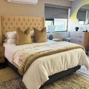 Mount Glow Self-Catering: a bedroom with a large bed and a mirror