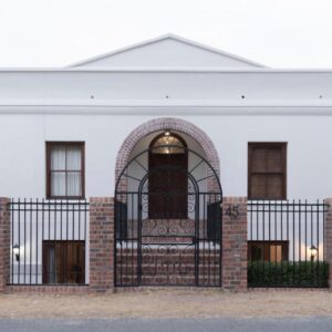 Mountain and Tides: a white building with a gate in front of it