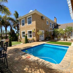 Mountainview Guesthouse: a swimming pool in front of a house