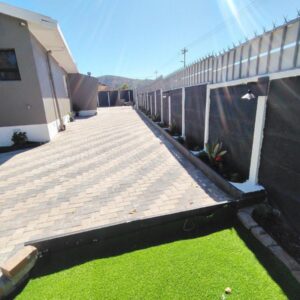 Nefeya lodge: a walkway next to a building with green grass