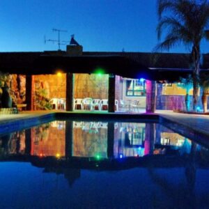 Oasis Country Lodge: a swimming pool in a house at night