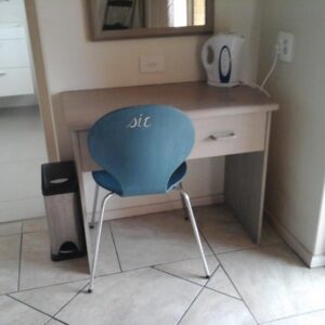 Old Post Office Lodge: a blue chair sitting in front of a desk