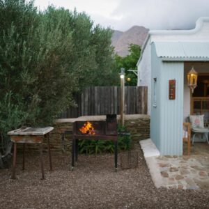 Olive Stone Farm Cottages: a fire pit in a yard next to a building