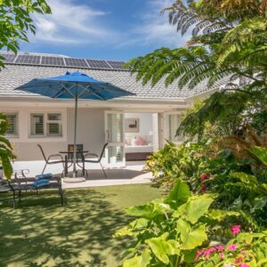 One on Bollard: a house with a patio with a table and an umbrella