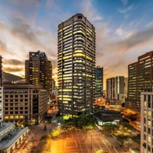 One Thibault Luxury Apartments: a city skyline with tall buildings at dusk