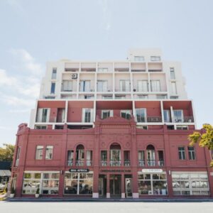 ONEHUNDRED on M - Fluent Serviced Apartments: a red building on the corner of a street