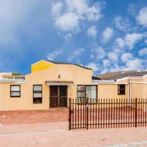 Oria Lodge: a building with a fence in front of it