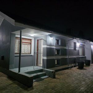 Pambazuko Guest House: a house at night with lights on it