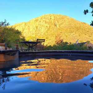 Porcupine Hills Olive and Guest Farm: a pool of water with a mountain in the background