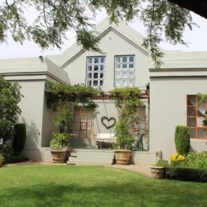 Potteberg Guest Farm: a white house with a heart painted on it