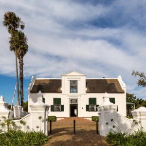 Protea Hotel by Marriott Cape Town Mowbray: a white house with a palm tree in front of it