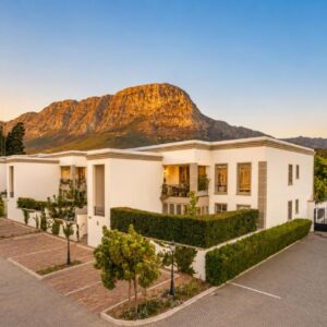 Rainbow Residence: a large white house with a mountain in the background
