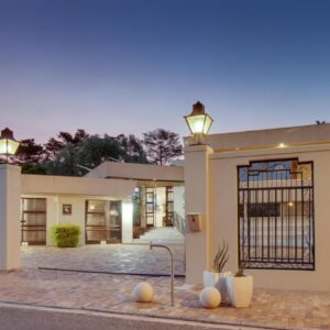 Ridgeworth Boutique Guesthouse: a house with a gate and lights on it