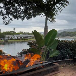 RiverBanks: a fire pit in front of a body of water