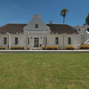 Robertson Manor: a large white building with a grass field in front
