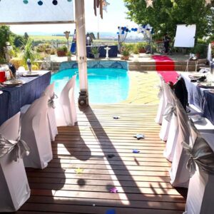 Roland’s Valley Art Accommodation: a table set up for a party next to a swimming pool at Roland\u2019s Valley Art Accommodation in Stellenbosch