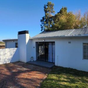 Sandrivier Farm Stay: a white house with a door on a yard
