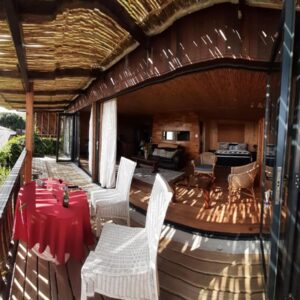 Scarborough Nature Lodge: a patio with a table and chairs on a house