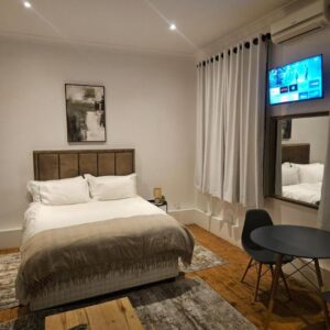 Shiloh Rock: a bedroom with a bed and a tv and a table