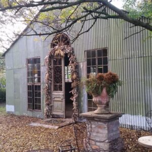 Simondium's Country Lodge: an entrance to a building with an arch and a fence