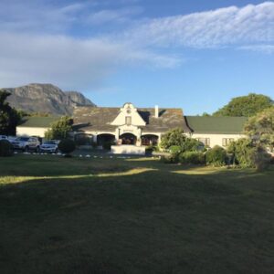 Somerset Guest Lodge - Western Cape: a house with a mountain in the background