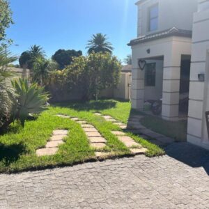 Southern Comfort Guest House: a garden with a walkway next to a house