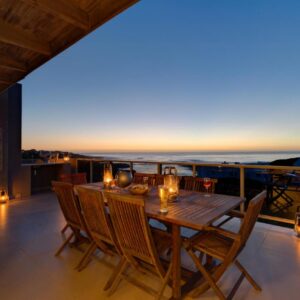 Stanford's Cove Villas: a dining table on a balcony with a view of the ocean
