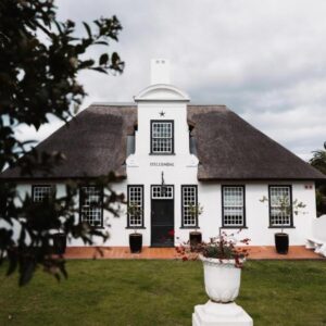 Stellendal House: a white house with a white vase in front of it