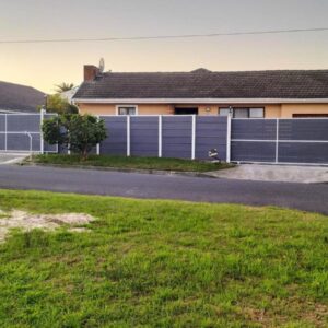 Step-by-Step Self-Catering and B&B: a blue fence in front of a house