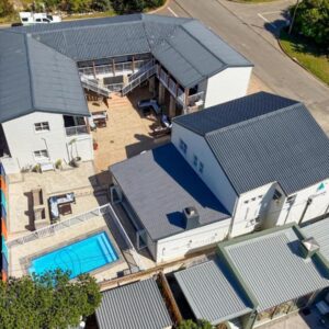 Stilbaai Harbour Inn: an overhead view of a house with a swimming pool