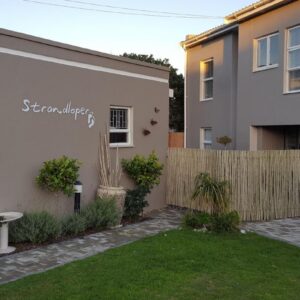 Strandloper Apartments: a backyard of a house with a fence