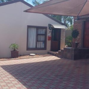 SuNel's Guest Rooms: a house with an umbrella in front of it