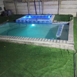 Sunrise Lodge: a large swimming pool with a pathway around it