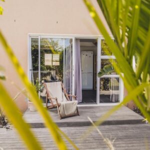 Surfers Lodge: a house with a porch with a chair