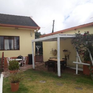 Taste Of Heaven: a house with a patio and a table and chairs