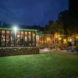 Thabile Lodge: a house with a green lawn in front of it at night