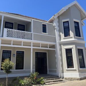 The Alma House 1900: a white house with a balcony