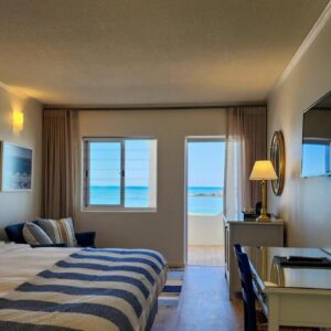 The Blue Peter Hotel: a hotel room with a bed and a desk