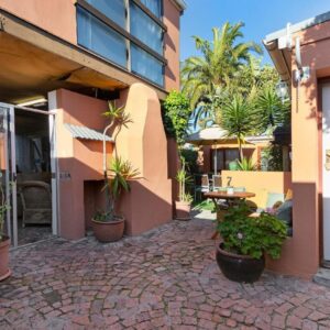 The Bohemian Guesthouse: a courtyard with potted plants next to a building