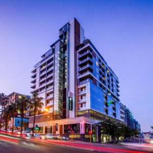 The Capital Mirage: a tall building on a city street at night