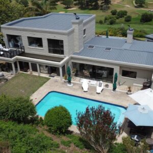 The Greens Guesthouse: an aerial view of a house with a swimming pool